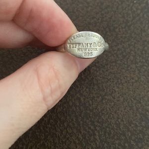 Please return to Tiffany & Co ring..used but still has the Tiffany charm!!
